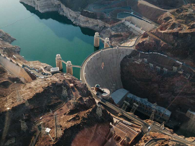 An aerial view of the Hoover Dam, showing the dam and nearby facilities