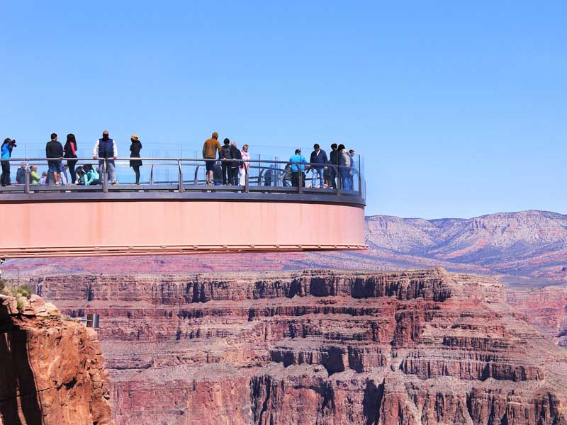 A group of people standing on the Grand Canyon West Skywalk