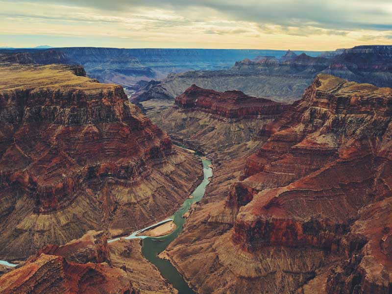 An aerial view of the Grand Canyon with a river running through it