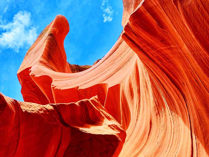 A close-up view of curved, red-orange rock formations at Antelope Canyon