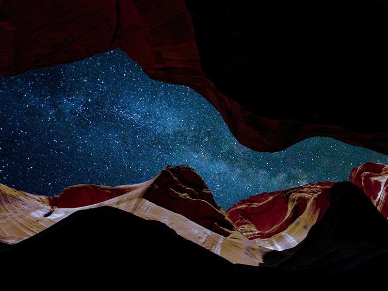 A starry night sky, as seen through a narrow opening between the walls of the Antelope Canyon