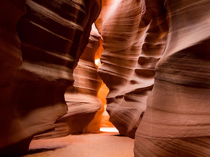 A narrow walkway through Antelope Canyon, with rock walls on either side