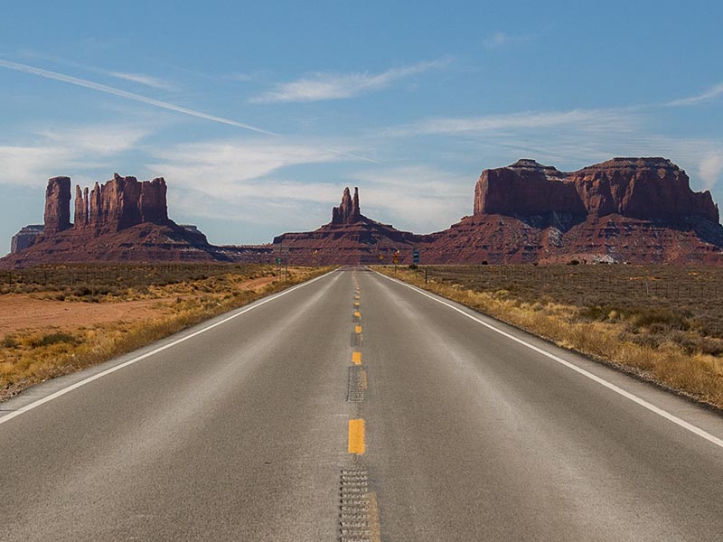 The paved road leading into Monument Valley, with buttes seen in the distance