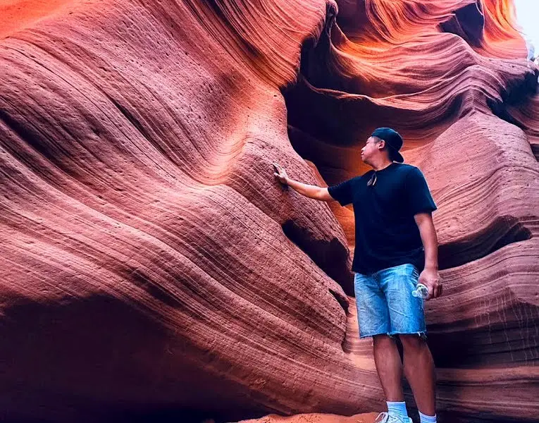 Tour Guest Feeling the Wall at Lower Antelope Canyon
