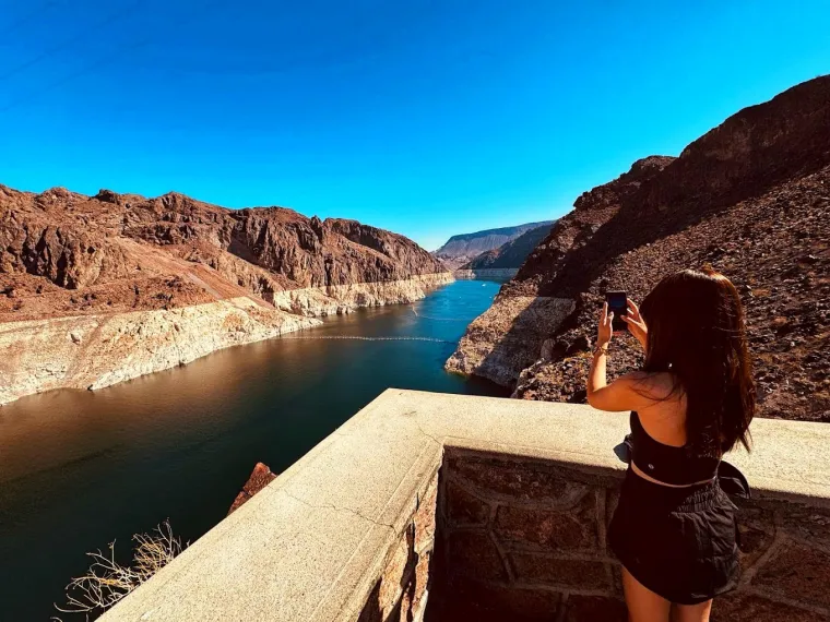Woman taking a photo of Lake Mead at the Hoover Dam