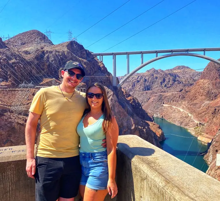 Couple posing in front of the Hoover Dam