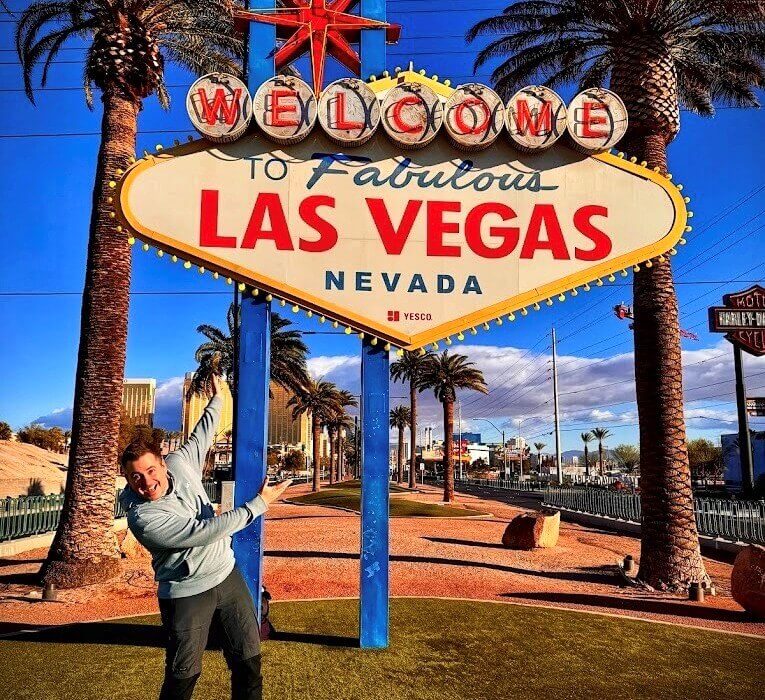 Man posing at Welcome To Las Vegas Sign