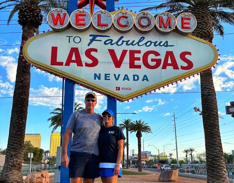 Couple posing in front of Welcome to Las Vegas sign